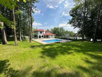 a house with a swimming pool in a yard at Mediterranean villa hot tub fire place•fire pit in Monroe