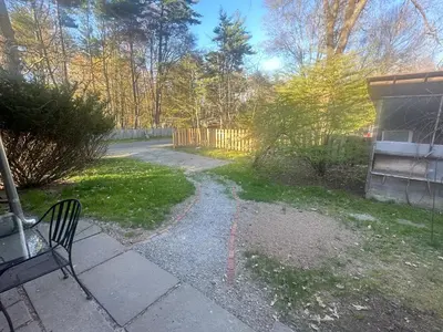 a path in a yard with a bench and a fence at Fiber Artist's Studio in Woodstock