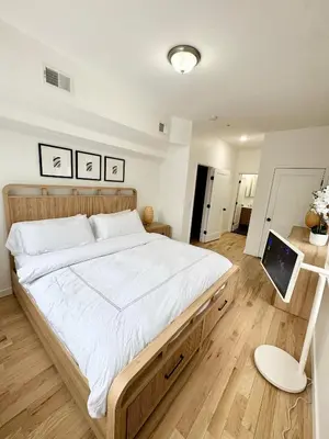 a bedroom with a large bed with a laptop on it at The Signature Modern Flat in Newark
