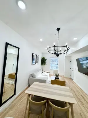 a living room with a table and a couch at The Signature Modern Flat in Newark