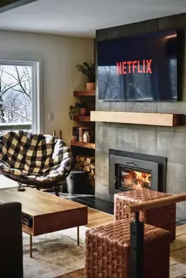 a living room with a television and a fireplace at NEW! Montview Chalet - Hot Tub, Sauna, EV, Views in East Stroudsburg