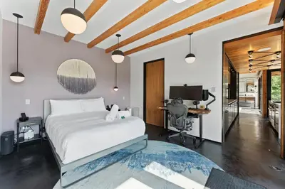 a bedroom with a bed and a desk with a computer at Hudson Ridge - Hot Tub, Fire Pit & Fireplace in Hudson