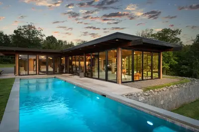 an exterior view of a house with a swimming pool at Hudson Ridge - Hot Tub, Fire Pit & Fireplace in Hudson