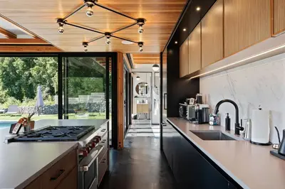 an open kitchen with a stove and a sink at Hudson Ridge - Hot Tub, Fire Pit & Fireplace in Hudson