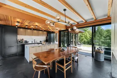 a kitchen with a wooden dining table and chairs at Hudson Ridge - Hot Tub, Fire Pit & Fireplace in Hudson