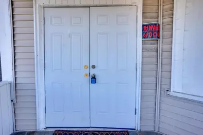 a white door on the side of a house at 2 Mi to Rutgers University! Urban Hub Near Parks in Newark