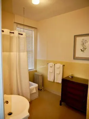 a bathroom with a toilet and a tub and a sink at Turkey Hill Inn in Summit