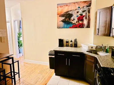 a kitchen with a sink and a counter top at Ultra-Modern Luxury Room Executive Stay Near NYC in Paterson