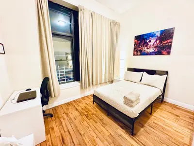 a small room with a bed and a window at Ultra-Modern Luxury Room Executive Stay Near NYC in Paterson
