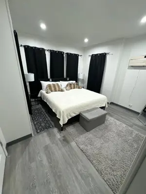 a bedroom with a bed with black curtains at 2 bed luxe townhouse-condo NewYork 30 Min Away in Kearny