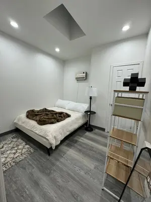a white bedroom with a bed with a blanket at 2 bed luxe townhouse-condo NewYork 30 Min Away in Kearny