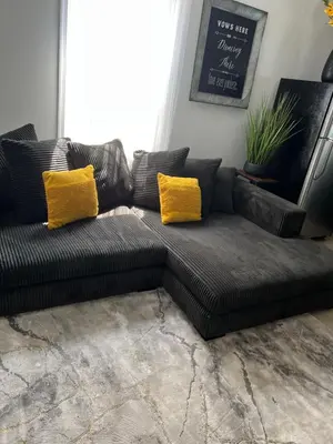 a black couch with yellow pillows in a living room at Secür Your Vacation Home in Jersey City