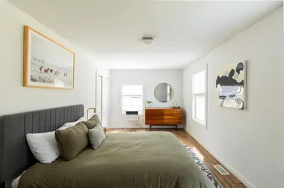 a bedroom with a bed and a dresser at Rustic Luxe Creekside Retreat with Hot Tub and Fire Pit, Minutes From Hudson in Hudson