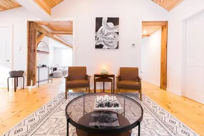 a living room with a table and two chairs at Rustic Luxe Creekside Retreat with Hot Tub and Fire Pit, Minutes From Hudson in Hudson