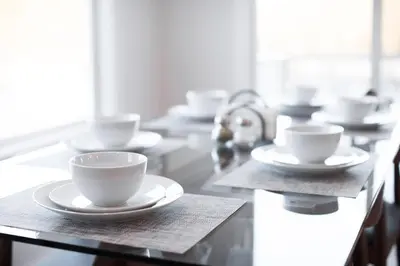 a row of cups and saucers on a table at Rustic Luxe Creekside Retreat with Hot Tub and Fire Pit, Minutes From Hudson in Hudson