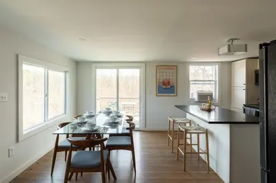 a kitchen and dining room with a table and chairs at Rustic Luxe Creekside Retreat with Hot Tub and Fire Pit, Minutes From Hudson in Hudson