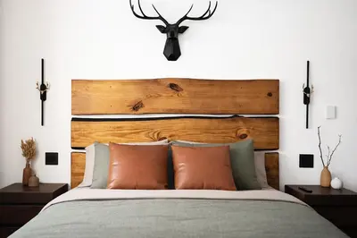 a bedroom with a bed with a wooden headboard at Blackwood Cabin Pocono in Pocono Farms East