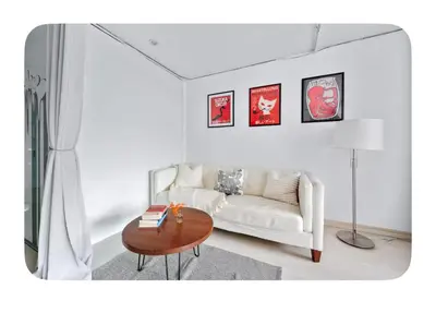 a living room with a white couch and a table at Bright and spacious apt, W&D in unit - Monthly in New York