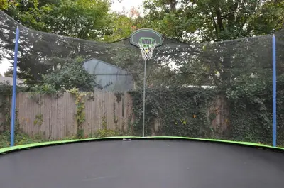 a basketball hoop with a basket on top of it at Family-Friendly Retreat With Trampoline & Grill in Locust Valley