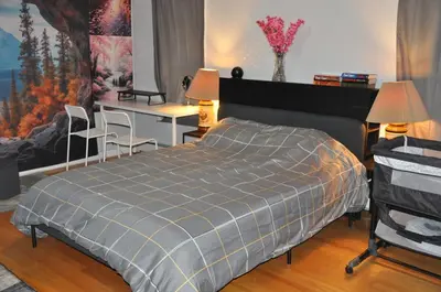 a bedroom with a bed and a desk and chairs at Family-Friendly Retreat With Trampoline & Grill in Locust Valley