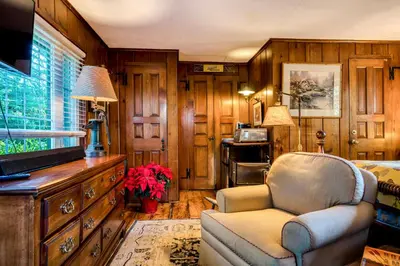 a living room with a chair and a dresser at Highland Ave in Norwalk