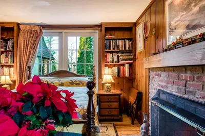 a bedroom with a fireplace and a bed and a window at Highland Ave in Norwalk