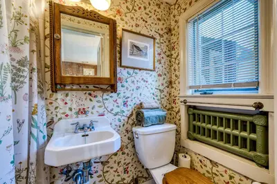 a bathroom with a sink and a toilet and a mirror at Highland Ave in Norwalk