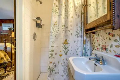 a bathroom with a sink and a shower curtain at Highland Ave in Norwalk