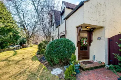 a white house with a brown door and a yard at Highland Ave in Norwalk