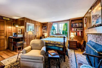 a bedroom with a bed and a chair at Highland Ave in Norwalk
