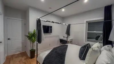 a bedroom with a bed and a lamp in it at Pristine Pad, Sleep 9, Free driveway park, 20 PERCENT OFF in East Newark