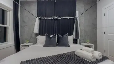 a bedroom with a large bed with two pillows at Pristine House, Sleep 21, Park 2 cars FREE, 20 PERCENT OFF in East Newark