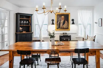 a dining room with a wooden table and chairs at The Swiss Hill Farmhouse - 5 Bedrooms w Hot Tub in Jeffersonville