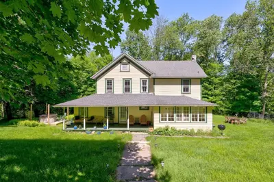 a yellow house with a gambrel roof at The Swiss Hill Farmhouse - 5 Bedrooms w Hot Tub in Jeffersonville
