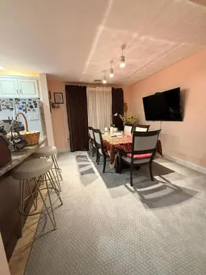 a kitchen and dining room with a table and chairs at House For Rent Near MetLife Stadium in Hasbrouck Heights