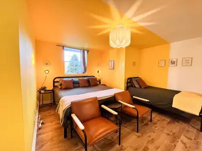 a bedroom with a bed and two chairs in it at PrivatePool|Hot tub|Sauna|HomeTheater|Backyard in Long Pond