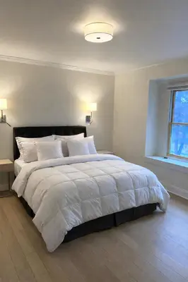 a bedroom with a large bed with white blankets and pillows at World Cup Stay Close to MetLife Stadium NYC in Waldwick
