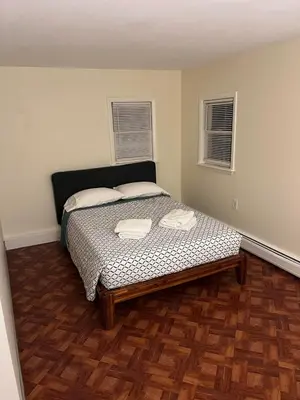 a bedroom with a bed with two towels on it at Cozy Stay Near Jiminy Peak & Bousquet Mountain in New Lebanon