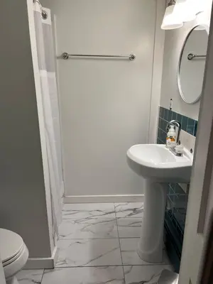 a white bathroom with a sink and a toilet at Cozy Stay Near Jiminy Peak & Bousquet Mountain in New Lebanon