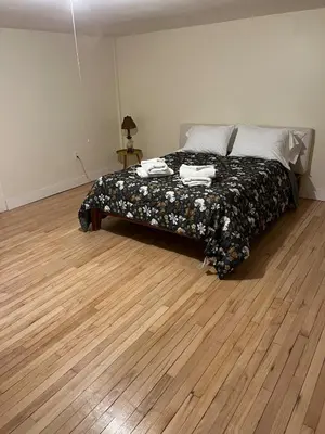 a bedroom with a bed and a wooden floor at Cozy Stay Near Jiminy Peak & Bousquet Mountain in New Lebanon