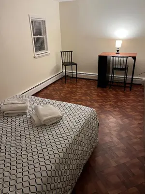 a bedroom with a bed and a table and chairs at Cozy Stay Near Jiminy Peak & Bousquet Mountain in New Lebanon
