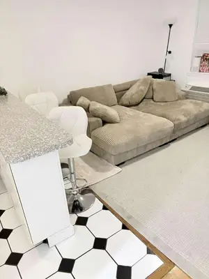 a living room with a couch and a table at Beautiful cozy place in HEART MANHATTAN in New York