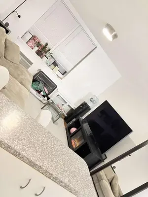 a living room with a couch and a flat screen tv at Beautiful cozy place in HEART MANHATTAN in New York