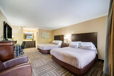 a hotel room with two beds and a couch at West Point Motel in Highland Falls