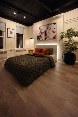 a bedroom with a large bed with orange pillows at Modern Loft Apartments, Stylish Design Near Midtown in New York