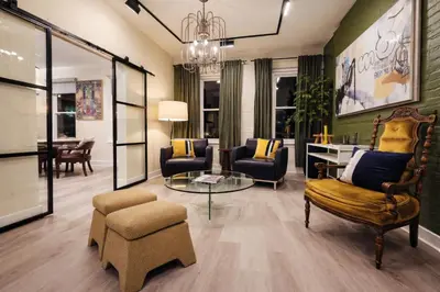 a living room with chairs and a table at Modern Loft Apartments, Stylish Design Near Midtown in New York