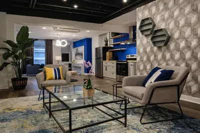 a living room with two chairs and a table at Modern Loft Apartments, Stylish Design Near Midtown in New York