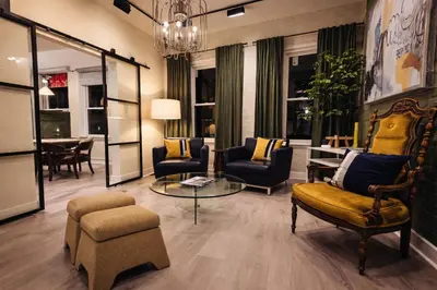 a living room with chairs and a table at Modern Loft Apartments, Stylish Design Near Midtown in New York