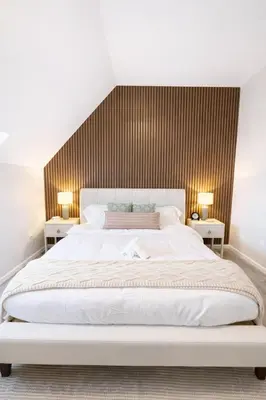 a bedroom with a large white bed with two tables at Yale Getaway Parking Wooster Square King Bed in New Haven