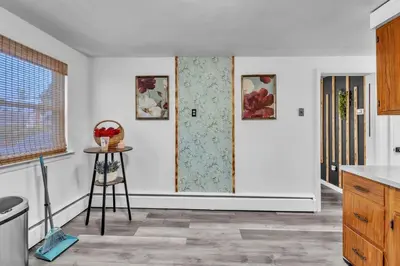 a kitchen with white walls and a door with a table at 4 Bedroom House Near Bristol Center in Bristol